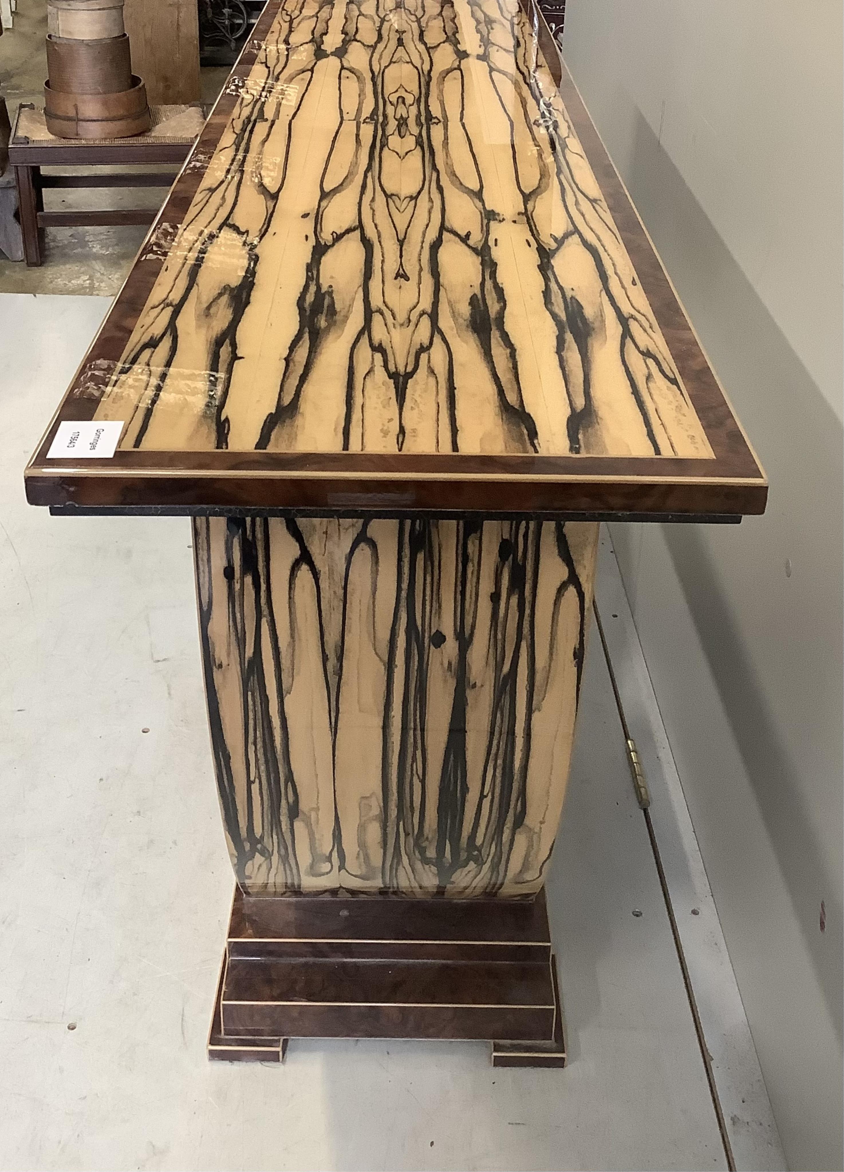 An Art Deco style white ebony and walnut console table